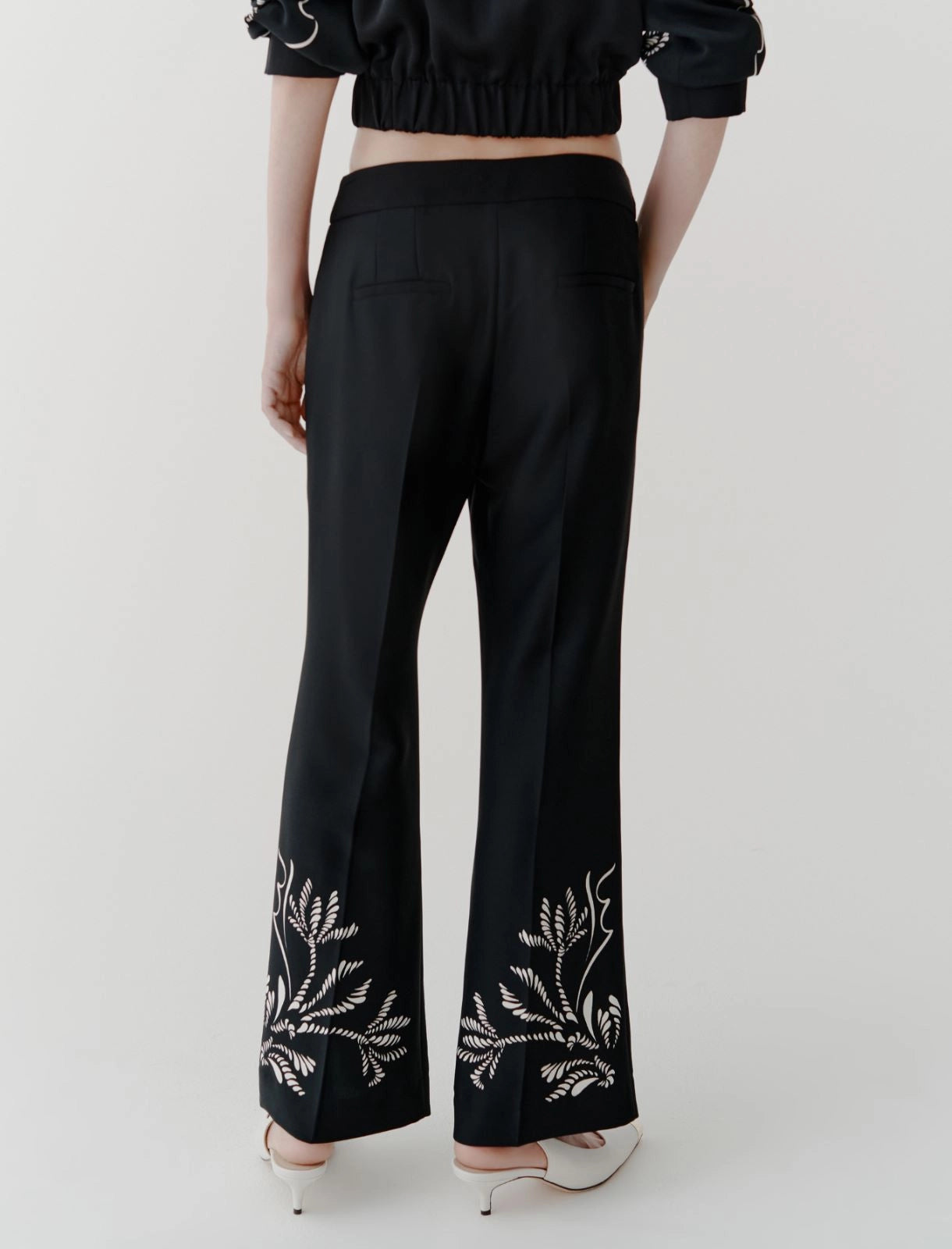 black placed flared satin trousers